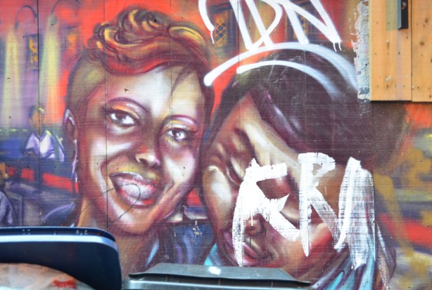 part of a mural, a couple, she has wavy hair pinned to the top of her head, 