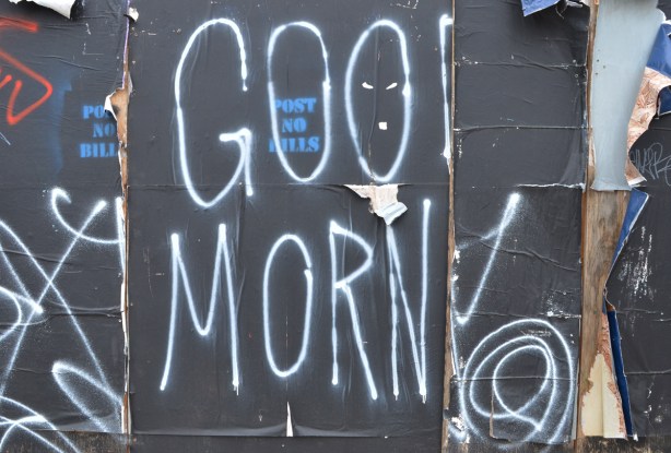 on black hoardings, large white letters that spell good morn 
