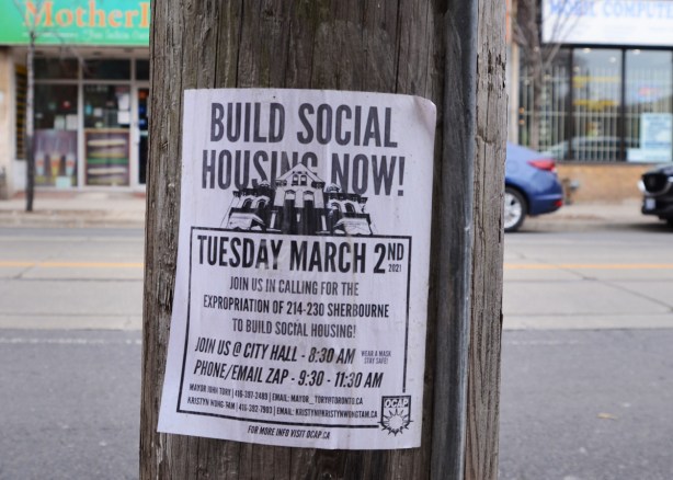 build social housing now poster on a pole, city hall protest, want to expropriate 214 to 230 Sherbourne Stret to build social housing