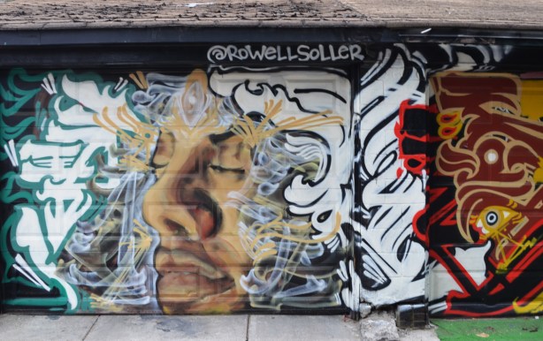 mural by rodwell soller, a mans face with eyes closed, calligraphy