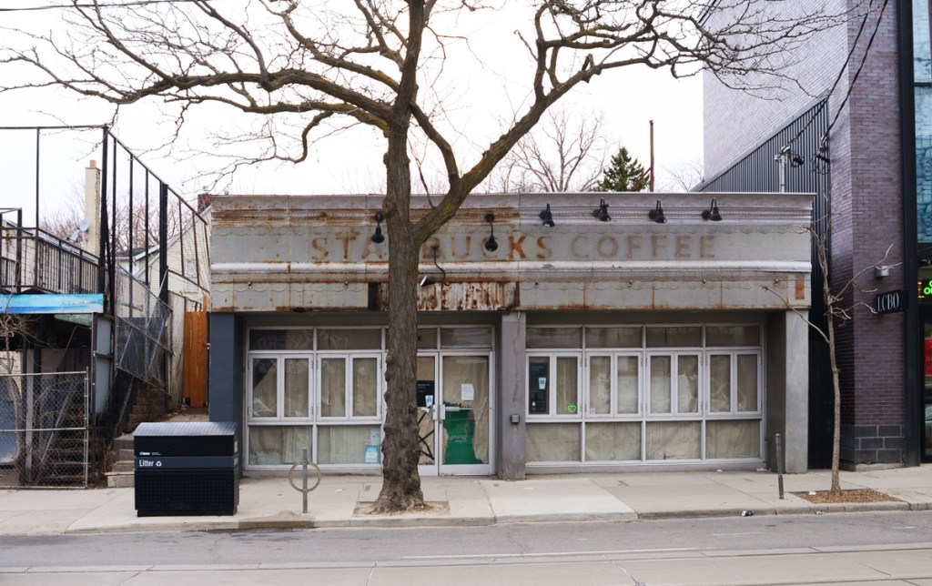 empty storefront, with ghost Starbucks coffee sign across the front