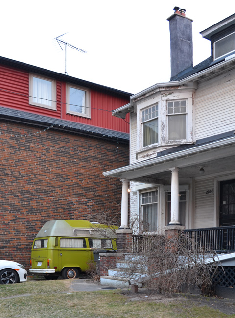 a lime green vw microbus parked in a driveway
