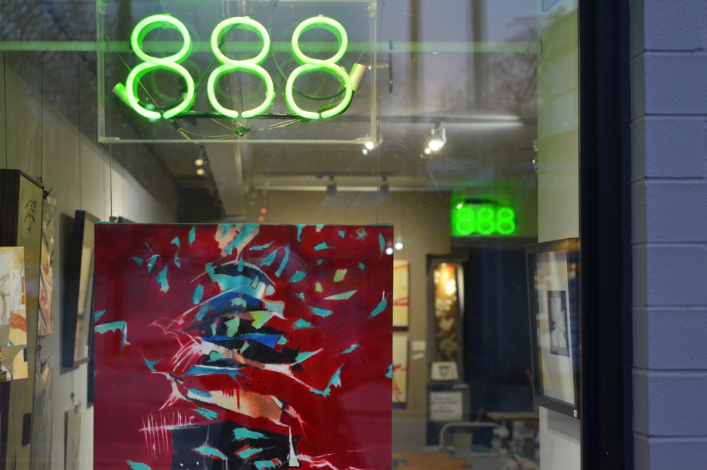 window of an art gallery at number 888, an abstract painting in the window predominantly red