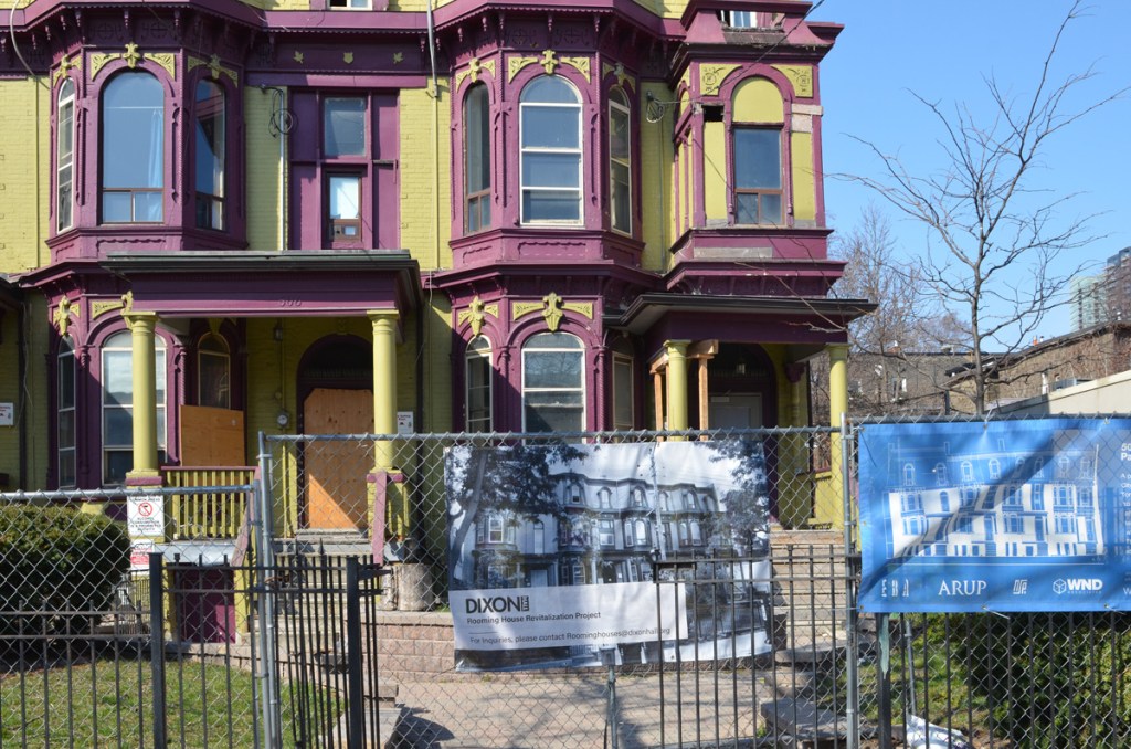 Dixon Hall, a series of rowhouses used as a rooming house is painted in purple and green.  it is boarded up and is about to be renovated