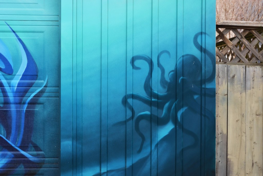 part of a mural, blue background with a darker blue octopus