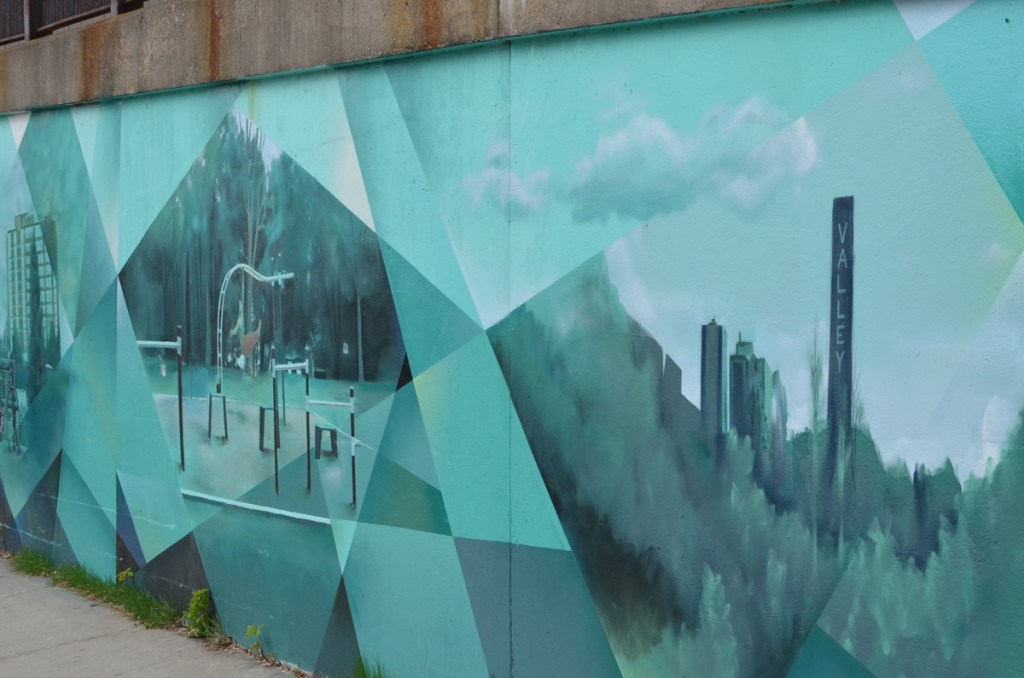 two scenes in the east end mural on Jones Ave by Jason Pinney, one is outdoor exercises and the other is the valley smokestack