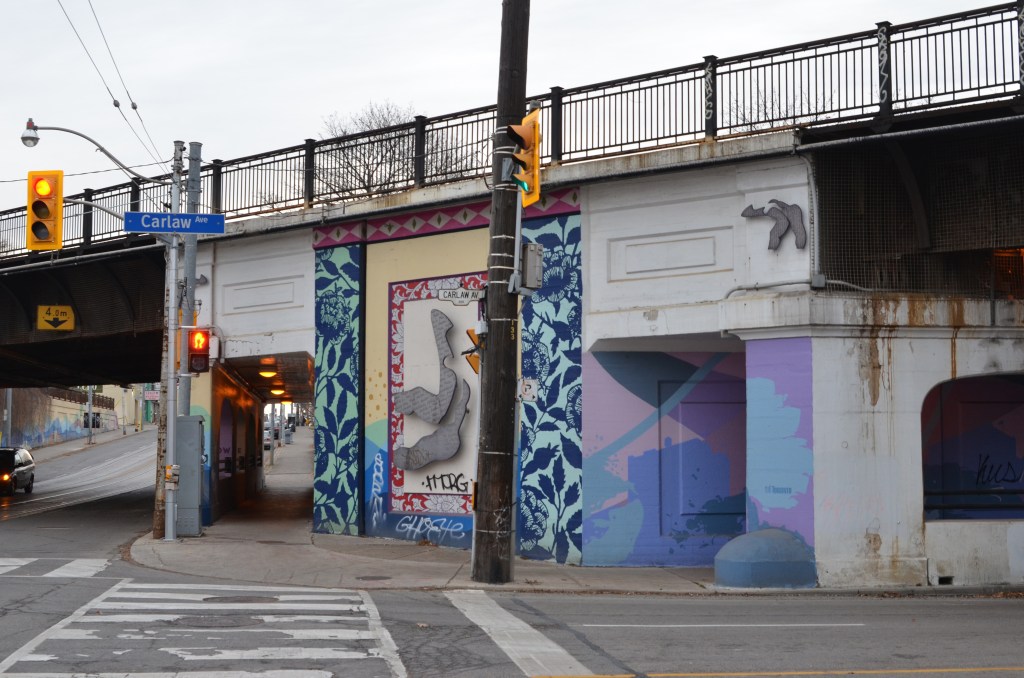 southeast part of intersection of Carlaw and Gerrard with railway overpass