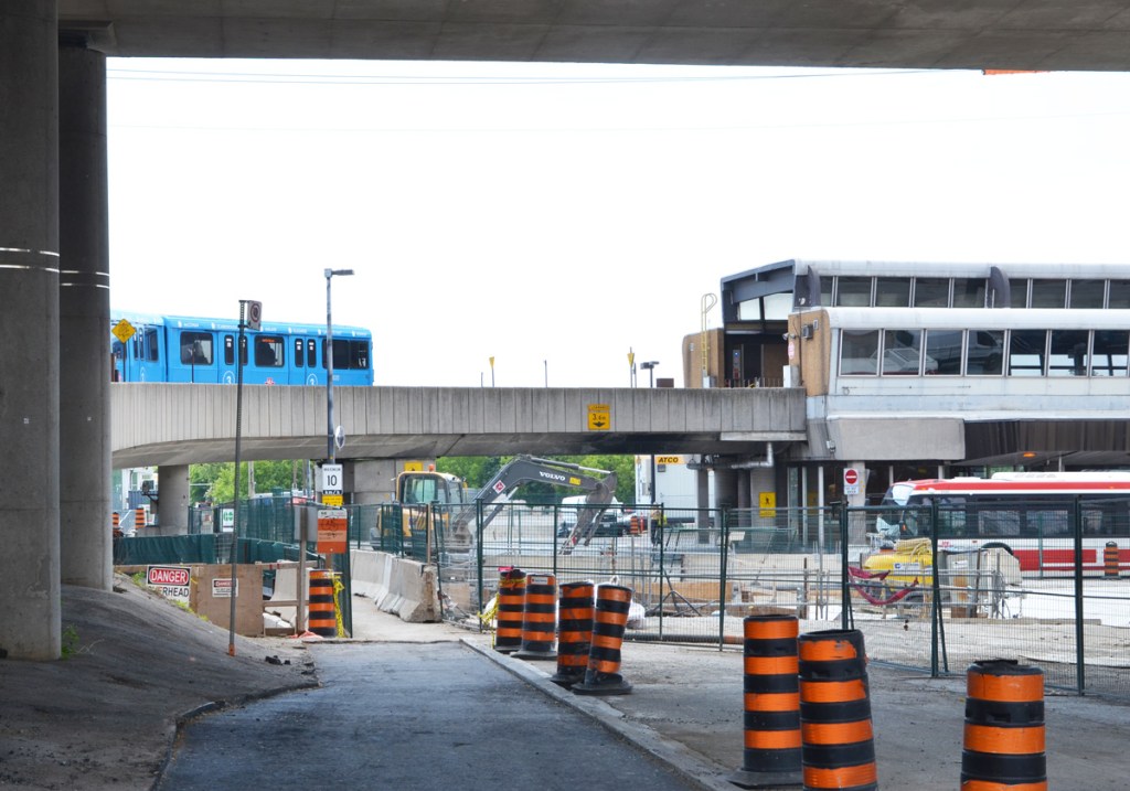 blue TTC sheppard line subway train enters Kennedy station after going up the curved concrete ramp 