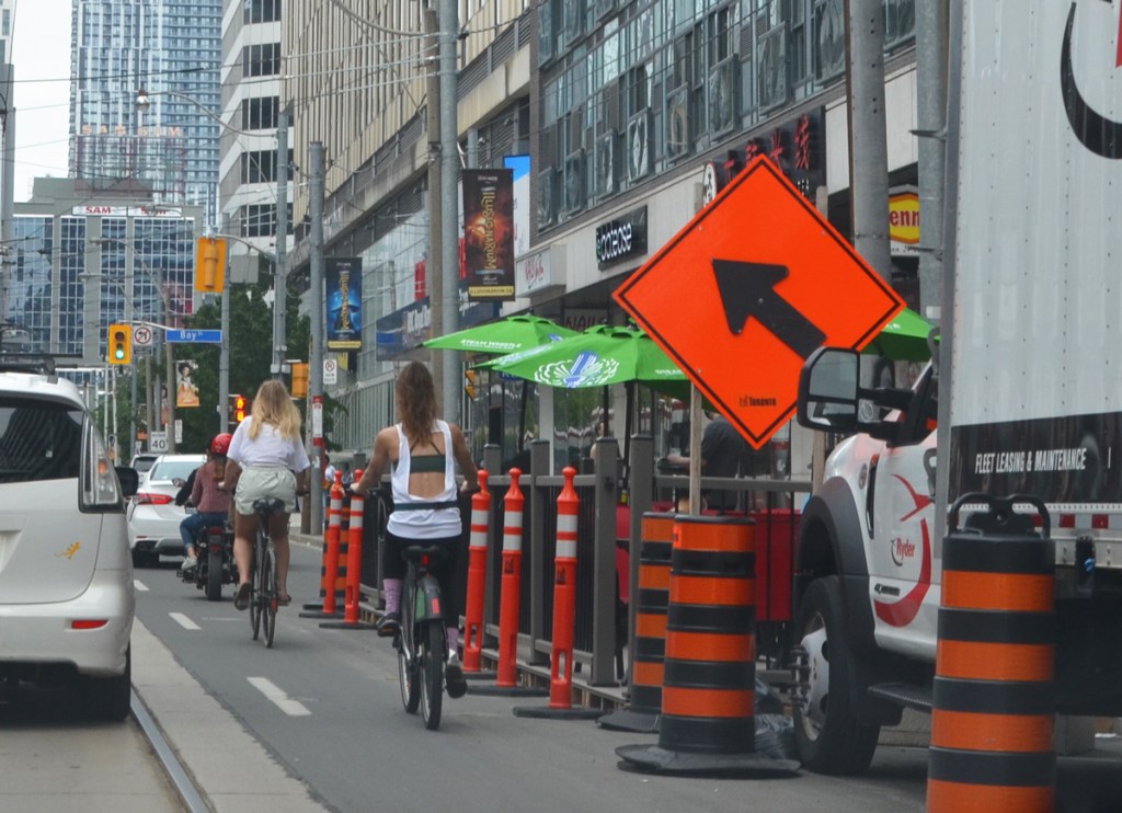 traffic, cyclists, construction cones, patio, on Dundas looking towards Bay street
