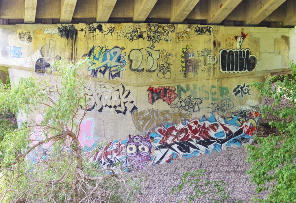 graffiti on the concrete supports of a bridge
