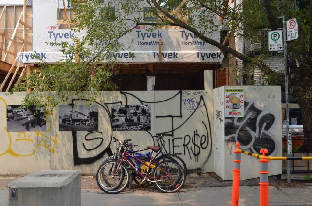 hoardings with an exhibit of old black and white photos of kensington