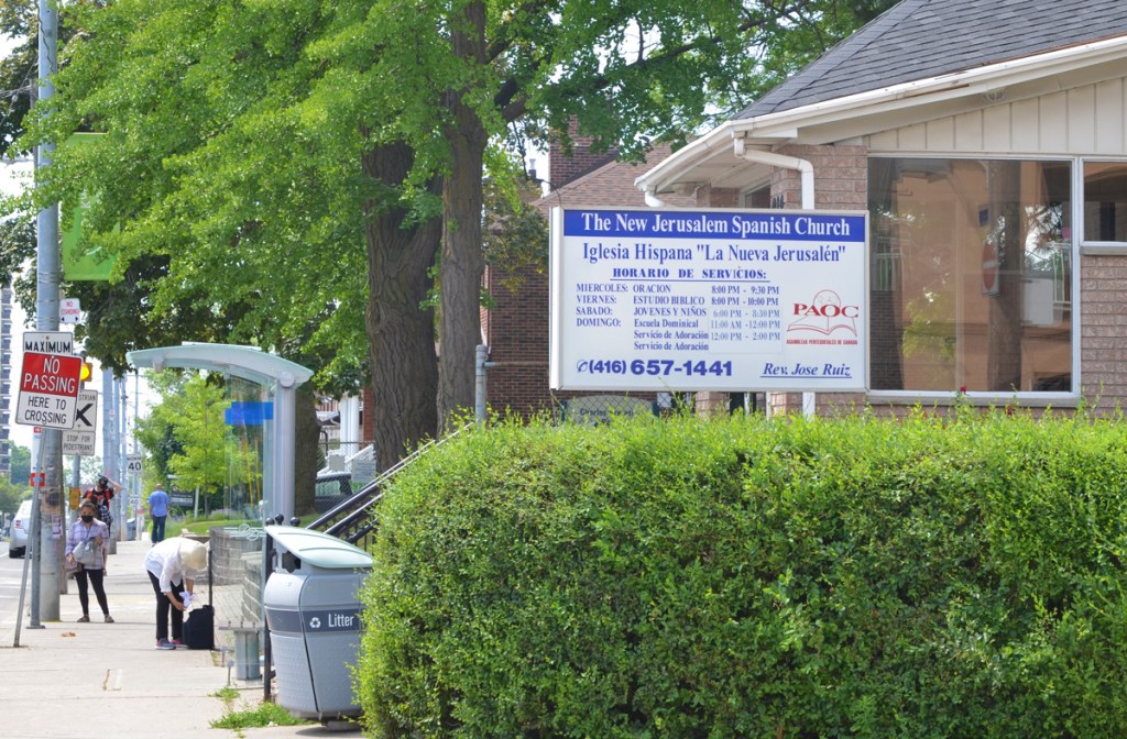 The New Jerusalem Spanish Church with a green hedge in front of it