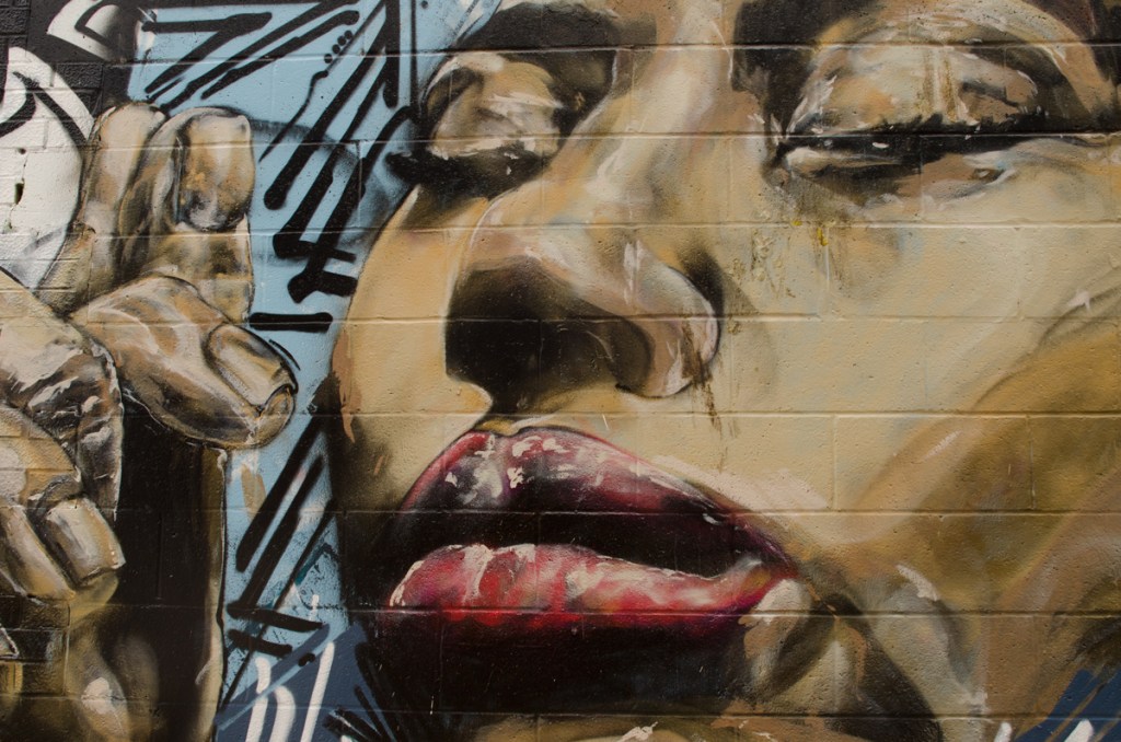 Close up of a face, eyes closed, mural by Rodwell Soller