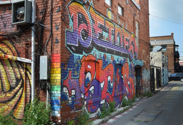 mural on a red brick building in a lane