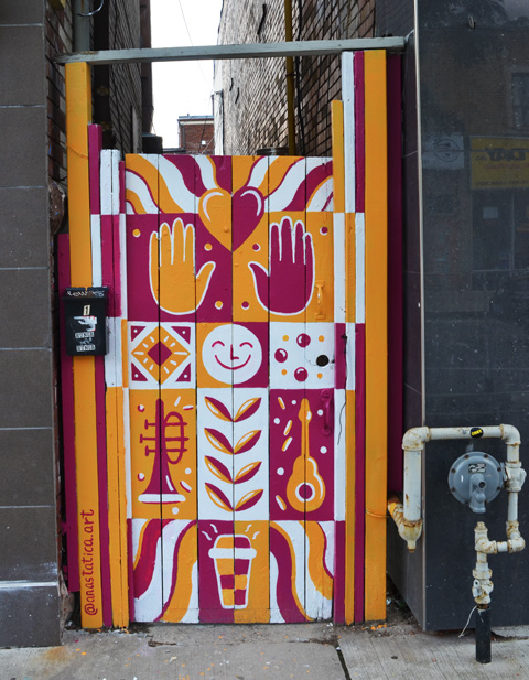 a gate painted in orange, maroon, sand white by anastatica art