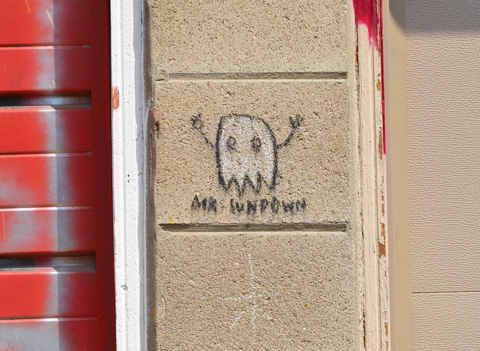 little white graffiti ghost character with stick arms, Mr. Sundown