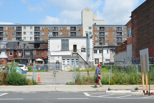 a man walks by a vacant lot on Bloor street