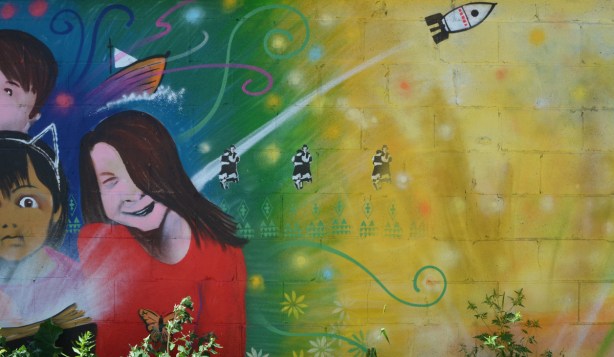 part of a mural in feel good lane, children, a rocket, and three stencils of a couple dancing