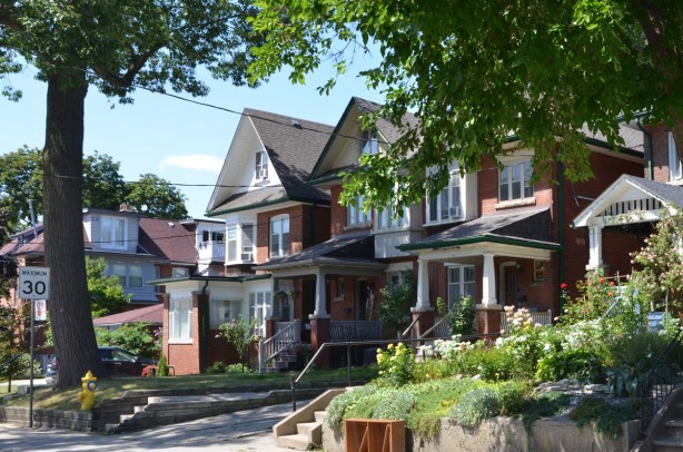 two storey brick houses in Regal Heights neighbourhood, large front porches and peaked roofs