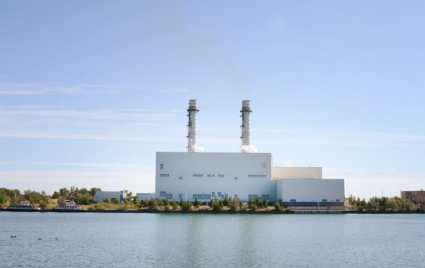 gas powered electric station on the shores of the Shipping Channel in the port lands, large white building with 2 tall smoke stacks 