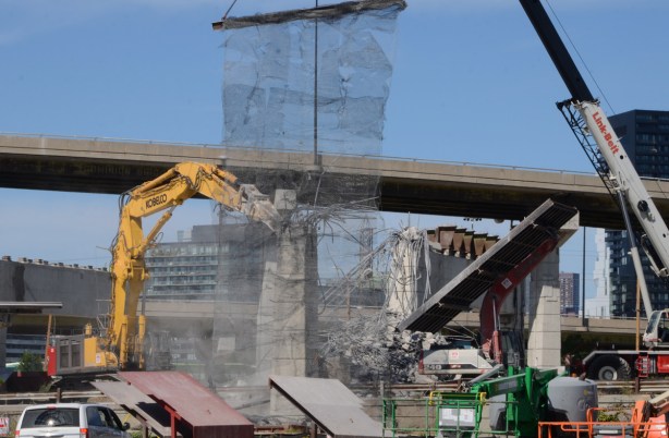 demolishing concrete bents under the Gardiner, catching debris in nets and on sliders that direct rubble to piles