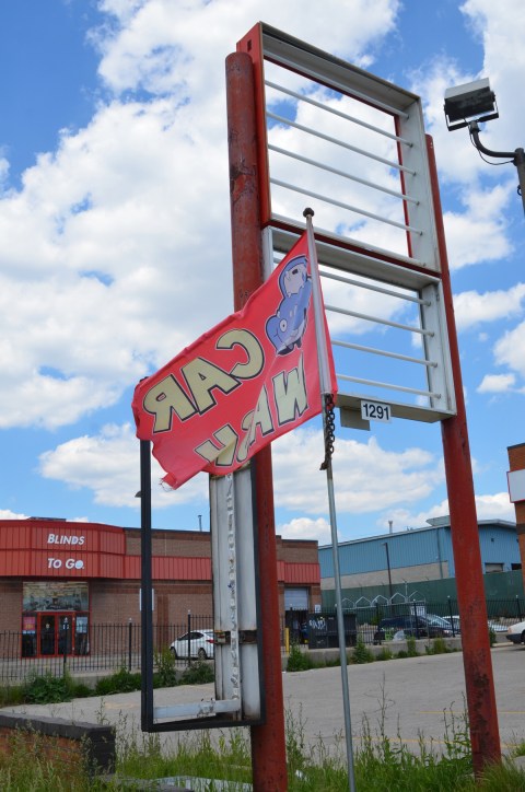 tall empty frame for a sign outside a closed business