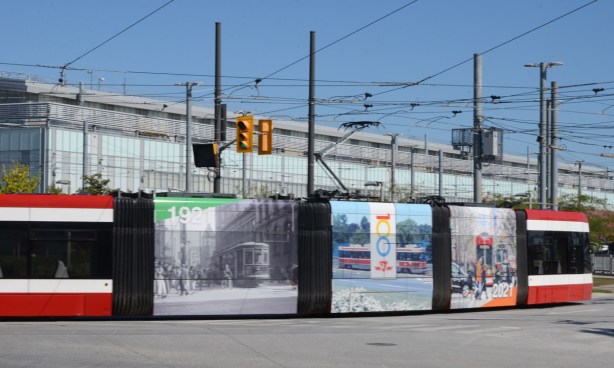 TTC streetcar leaving Leslie Barns, sides are decorated with pictures commemorating 100 years of the TTC