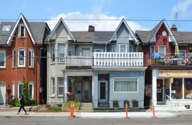 semi divided house with peaked roof, balconies on upper level 