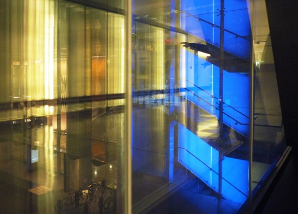lights shining through exterior glass walls, blue lights on a staircase