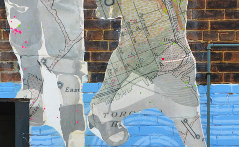 detail of map on legs of people in photos printed on maps
