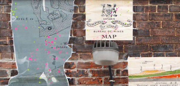 old provincial department of lands, forests, and mines symbol crest altered to read hands, florests, and minds and pasted onto a wall 