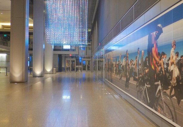 interior of 25 York street with 2 art installations, the hanging glass and lights, and a long mural by Michael Awad