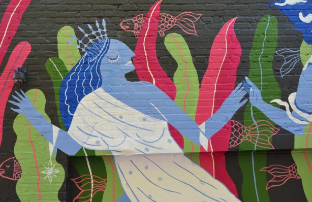 part of a mural with theme of water, blue woman dancing with eyes clsed