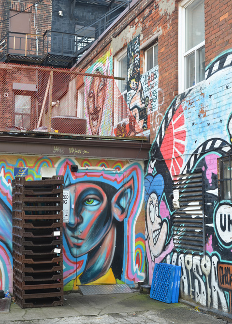 back of kaiser hotel, with philip saunders paintings of heads on two levels, other paintings there too 