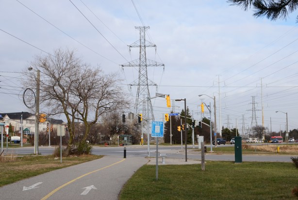 Meadoway path approaches the intersection of Sheppard Ave East and Dean Park with its hydro wires and towers