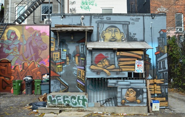mural by elicser on back of building in alley