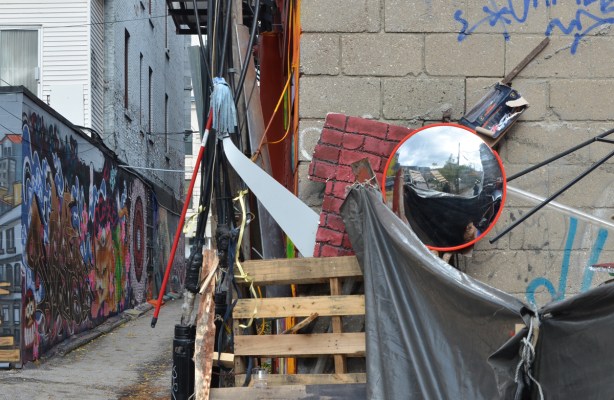 stuff in alley, a mop, circular mirror, wood pallet