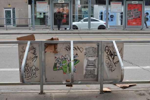 on the back of a bike rack, pasteups and stickers, urban ninja squadron in green, 