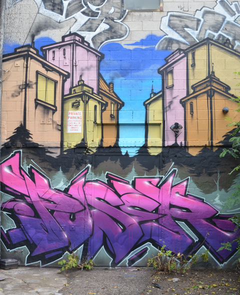 mural in El Mocambo Lane by poser, houses on a street with his tag below