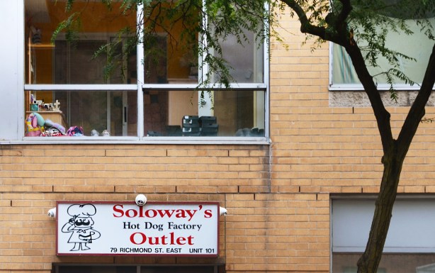 sign over entrance to Soloways Hot dog factory outlet in nondescript brick building
