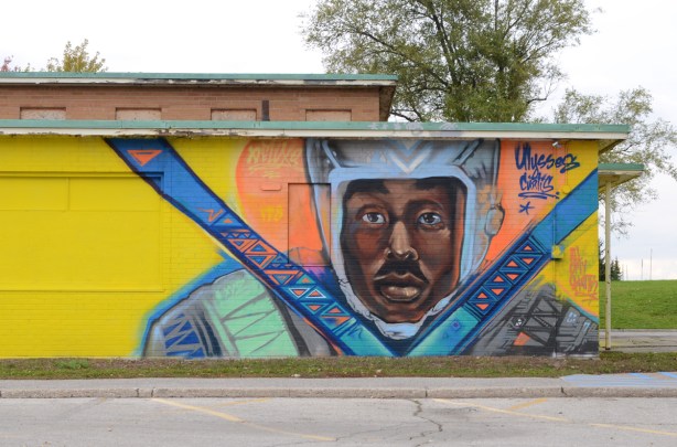 mural, black man with helmet and shoulder harness straps