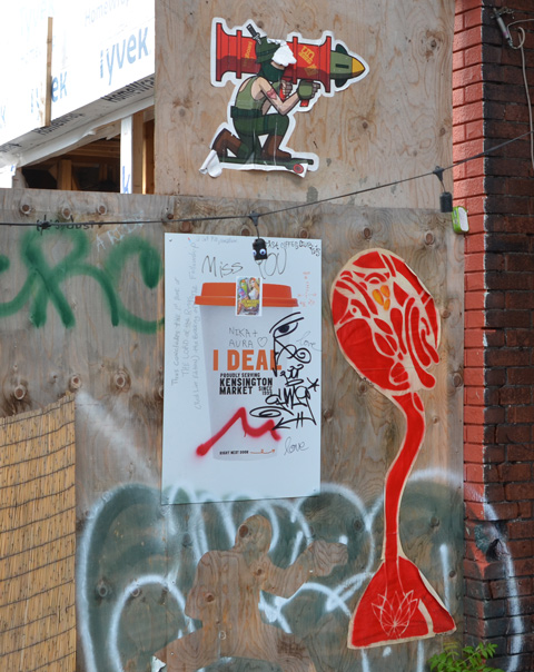 on plywood hoardings, coffee cup poster, with t-bonez and a large missile in the background