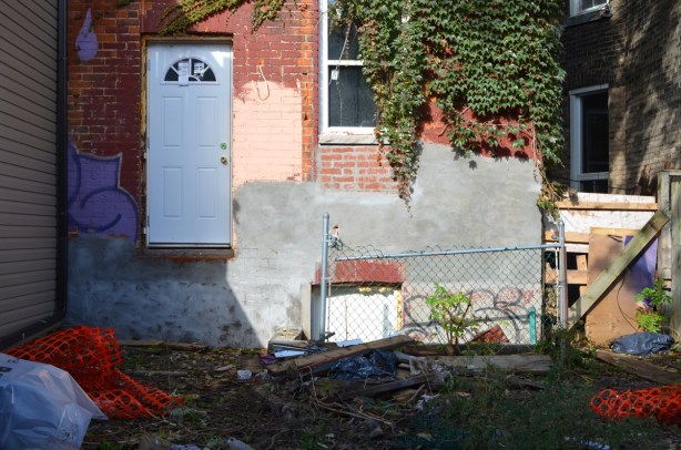 back of a house being renovated with the new door high above the ground, no stairs made yet