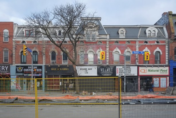 old building, now stores, on Queen Street West at the top of Portland Street