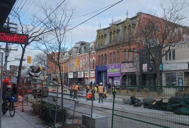 workmen working on the TTC streetcar tracks on Queen West