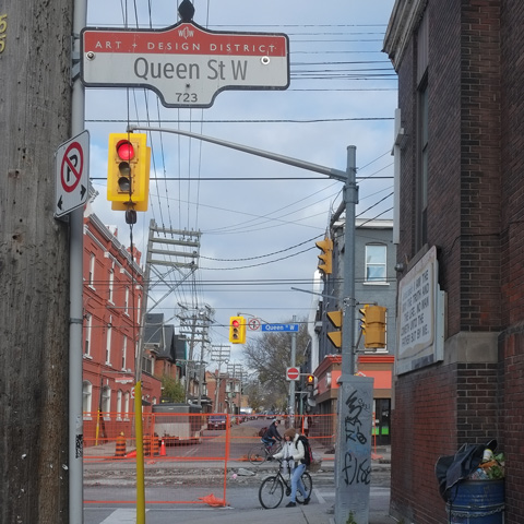 two cyclists on queen street west