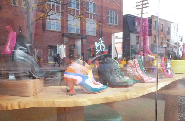 reflections of street scene in window of John Fluevog shoes on Queen West 