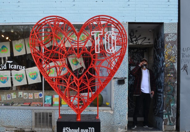 red heart made of a web of metal with white T and O in the top right corner, show love T O
