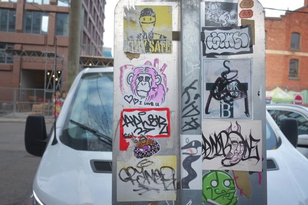 stickers on poles in graffiti alley