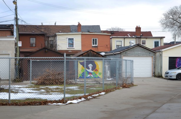 bright and colourful mural in an alley of a woman